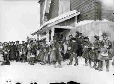 Samer tillsammans med kyrkoherde Vitalis Karnell utanför Karesuando kyrka, 1913.